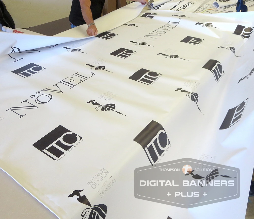 Labor preparing vinyl banners